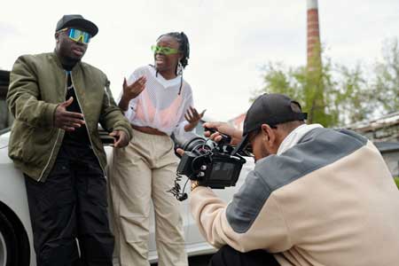 8-mile-studios-shades-bts 2 actors with a cameraman shooting them